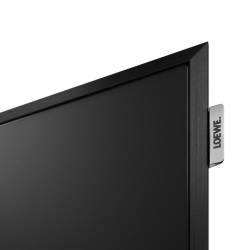 Loewe stellar 55 dr+ lava OLED TV Nahaufnahme Rahmen mit Loewe Logo – Design Fernseher mit Beton- und Lavaoberfläche